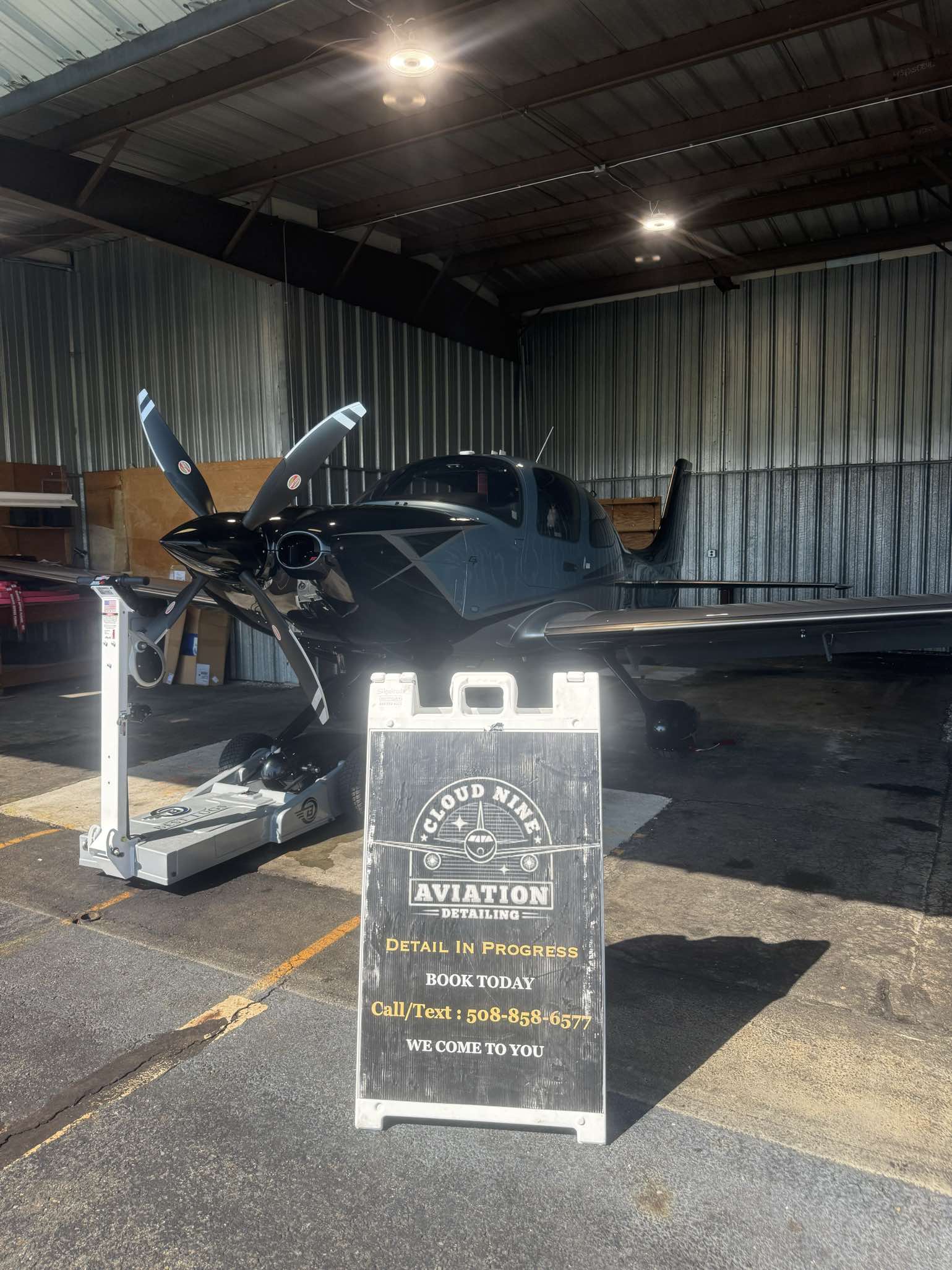 Aircraft parked in a hangar at Beverly Airport during detailing