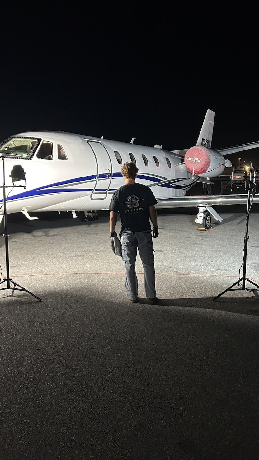 Private jet receiving nighttime ramp service at Barnstable Municipal Airport