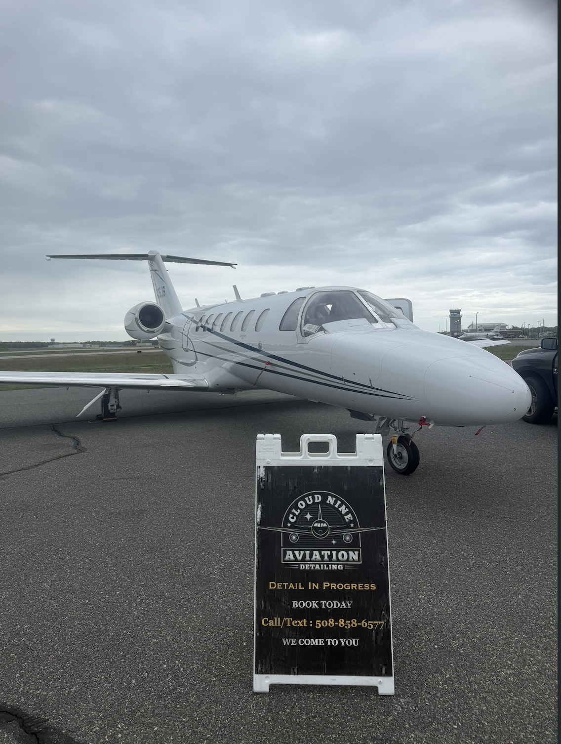 White business jet on the ramp at a New England airport