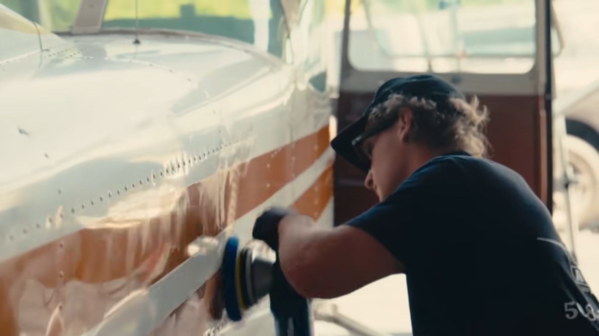 Cloud Nine Aviation technician machine-polishing an aircraft fuselage
